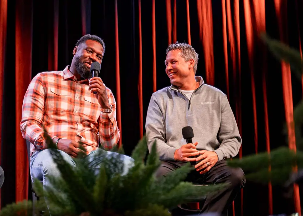 Two men speaking with microphones