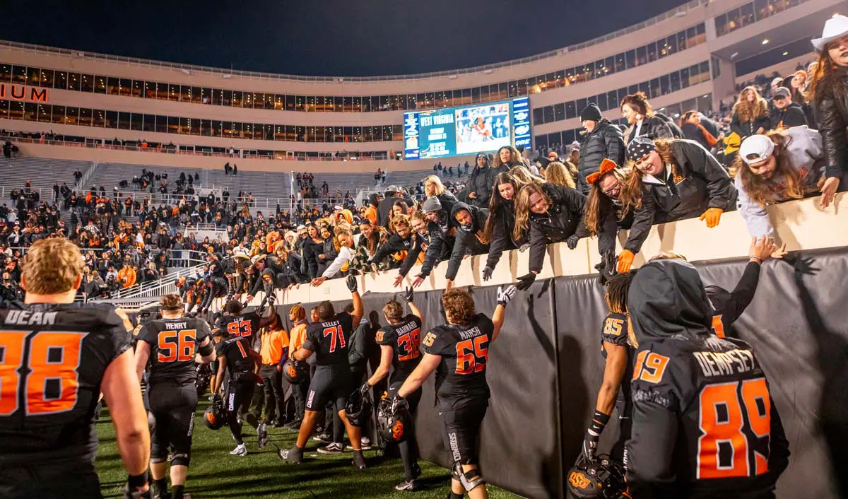 football players high fiving fans